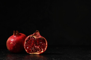 Tasty ripe pomegranate on black background