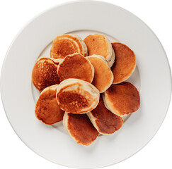 Golden mini pancakes are stacked on a white plate, perfect for a quick breakfast.