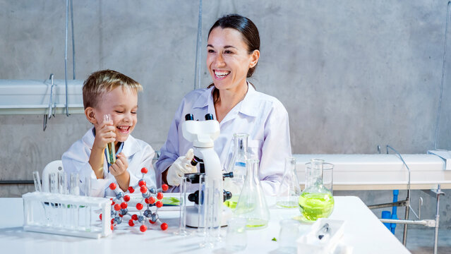 A happy child and female scientist conduct a chemistry experiment in a bright lab. They explore eco-friendly farming innovations and science learning through hands-on experiments and teamwork.