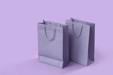 Shopping bags on lilac background