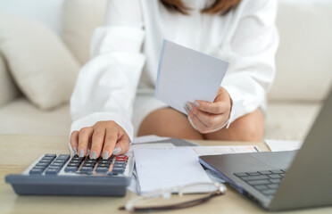 Human use calculator and calculate bills and paying bill, credit card, tax and vat, payment, concept of money management and business report with financial documents, financial accounting concept