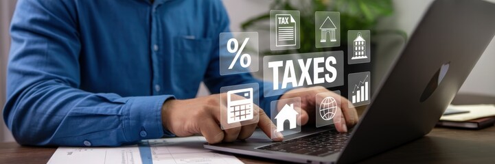 Person working on a laptop with taxes displayed.