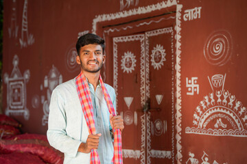 young indian asian farmer standing confidently at home