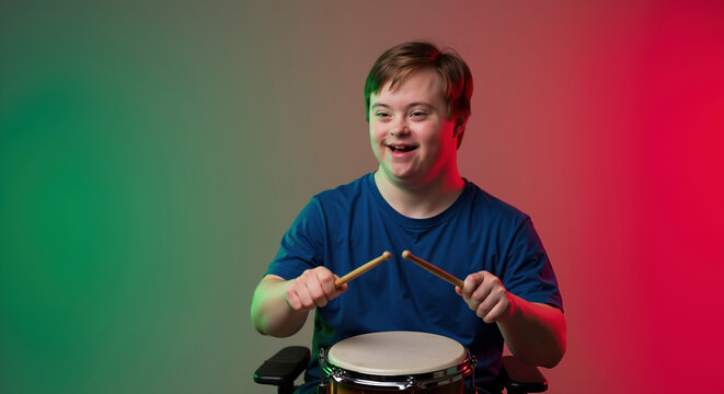 Smiling boy with down syndrome holding drumsticks, blue shirt, green red gradient background. Special needs child music education, inclusive arts concept