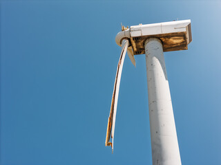 Broken wind turbine blade after structural failure on clear sky day