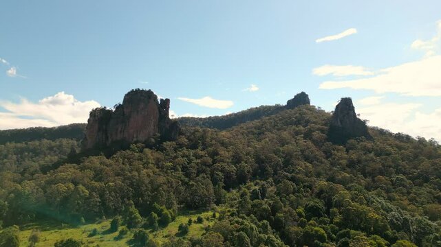 Slight tilt and move forward towards rocky peaks.