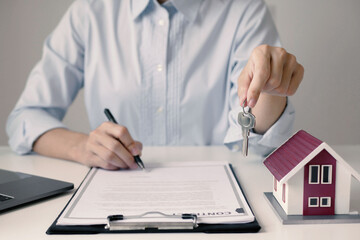 Businesswoman real estate agent signs documents and gives home insurance advice Create a home...