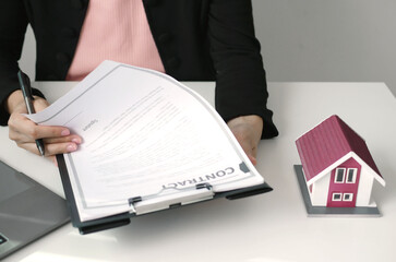 Businesswoman real estate agent signs documents and gives home insurance advice Create a home...