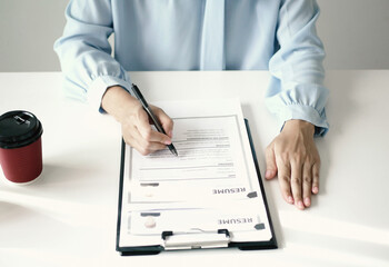 Senior businesswoman executive reviewing new job applicant documents, reading resume and...