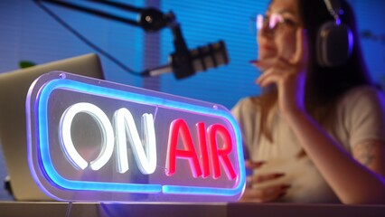 Podcast Studio with Host and On Air Neon Sign