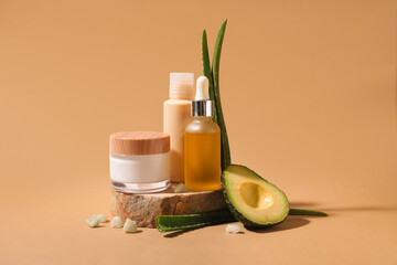 Composition with natural cosmetic products, aloe leaves, avocado and sea salt on color background