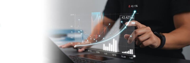 Person interacting with a holographic financial analysis overlay.