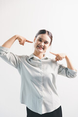 Asian woman rejoicing, looking happy, champion, fist pump gesture, standing over white background....