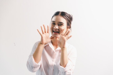 Asian woman rejoicing, looking happy, champion, fist pump gesture, standing over white background....