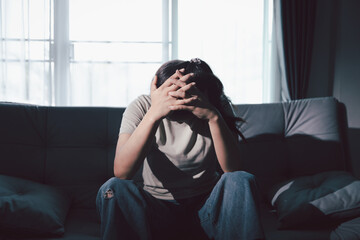 Despair sorrow person in empty dark room, Depressed young woman covering face with hands. Young...