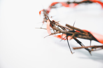 Crown of thorns on white table background. Easter, central celebration in Christianity, honors...