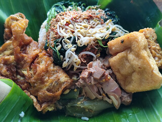 Nasi pecel or sego pecel is a typical Javanese Indonesian rice dish served with pecel sauce, which...