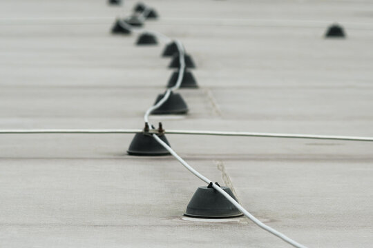 Close-up of lightning rod and grounding system installed on roof of building