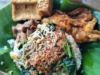 Nasi pecel or sego pecel is a typical Javanese Indonesian rice dish served with pecel sauce, which...