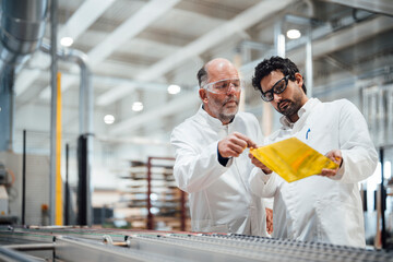 Engineers discussing product development in a factory setting