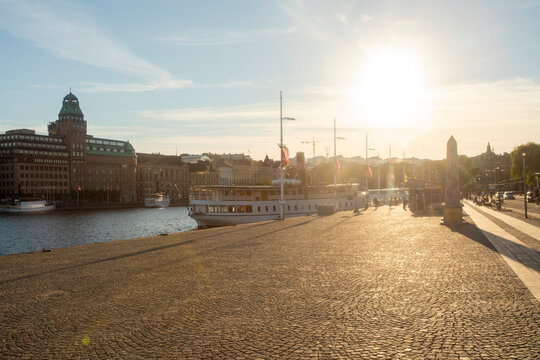 Sunny summer day at Strandvagen promenade in Stockholm with boats docked.