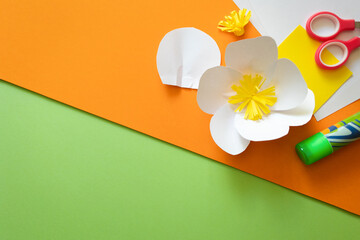 summer paper flowers on bright orange background . kids art craft diy gift