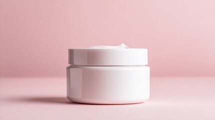 Minimalist white skincare jar with lid on soft pink background for beauty product display.