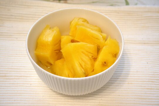 Chopped pineapple in white bowl. - Powered by Adobe