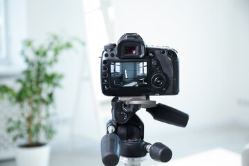Shooting houseplant and mirror with professional photo camera in studio, selective focus