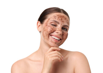 Smiling woman with body scrub on her face winking against white background