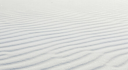 Obraz premium Subtle, parallel ripples etched into pristine white sand, a textured expanse of desert dunes.