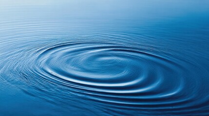 Calm blue water surface with gentle ripples creating concentric circles in natural outdoor setting.