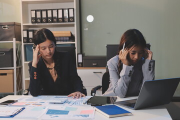 Asian women are stressed while working on laptop, Tired asian businesswoman with headache at...