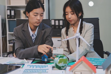 Asian woman lead young group of multiethnic businesspeople in team meeting, using laptop computer for ESG topic presentation on monitor. Sustainable business practice, people work at home concept