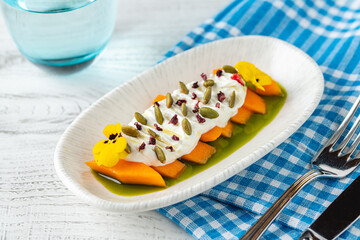 Zucchini and yogurt appetizer with capers and edible flowers