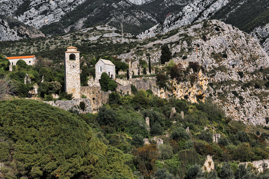Venetian and Osman citadel ruins in Old Bar, Montenegro with clock tower and medieval stone buildings in mountainous landscape