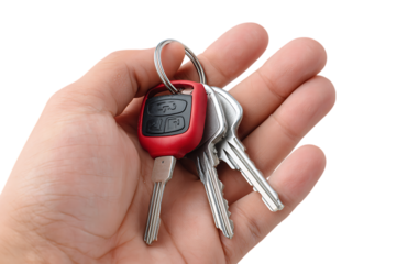 Hand holding a bunch of car keys with a red fob isolated on transparent background