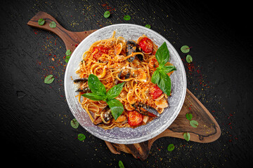 Italian pasta with shrimp, mussels, and calamari in a creamy sauce on a dark background. Classic seafood dish.