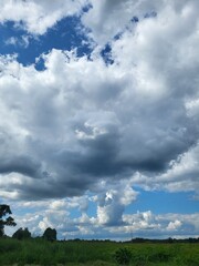 Fluffy white clouds in a blue summer sky