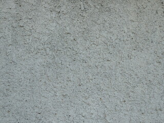 plaster on wall as textured background gray color with faceted surface and uneven rough relief,...