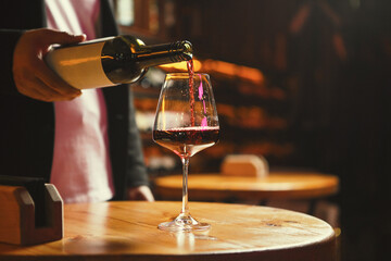 Glass Being Filled with Red Wine at Wine Bar