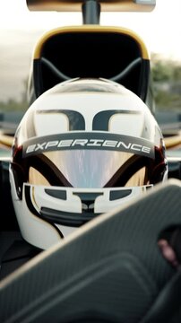 Extreme close-up of a race car driver driving along the race track wearing a protective helmet with experience slogan. 3d animation rendering. New 2025 black and gold race car design