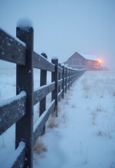 Rustic wooden fence and small building on a snowy field.