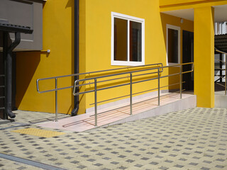 Close-up of wheelchair ramp at the entrance of a residential building.