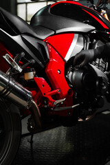 Motorcycle Oil Refill. Replacing engine oil in a sports motorcycle to ensure top performance and engine longevity. Precision oil fill operation on a red sportbike to ensure proper engine lubrication.