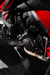Mechanic working on motorcycle crankcase during full maintenance inspection. Motorcycle crankcase...
