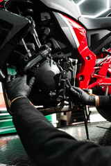 Motorcycle crankcase inspection with ratchet wrench ensures performance efficiency. Mechanic...