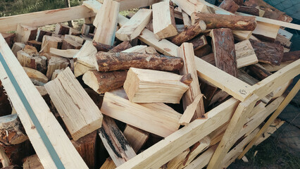 Heap firewood stack, natural wood. Cut firewood top view. Stock of firewood for heating house.