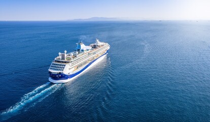 Aerial view of a generic cruise ship sailing over blue ocean with copy space as a concept for...