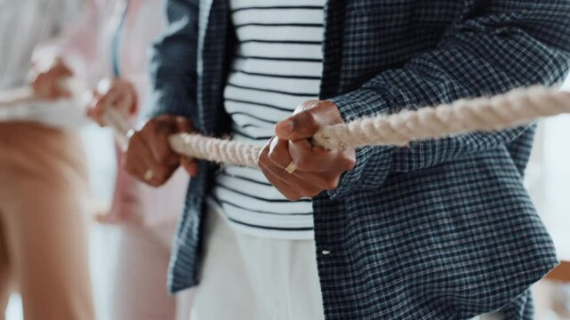 Pull rope, teamwork and hands for competition, game and challenge with business people in office. Group, tug of war and cooperation with strength, power and collaboration with synergy for contest